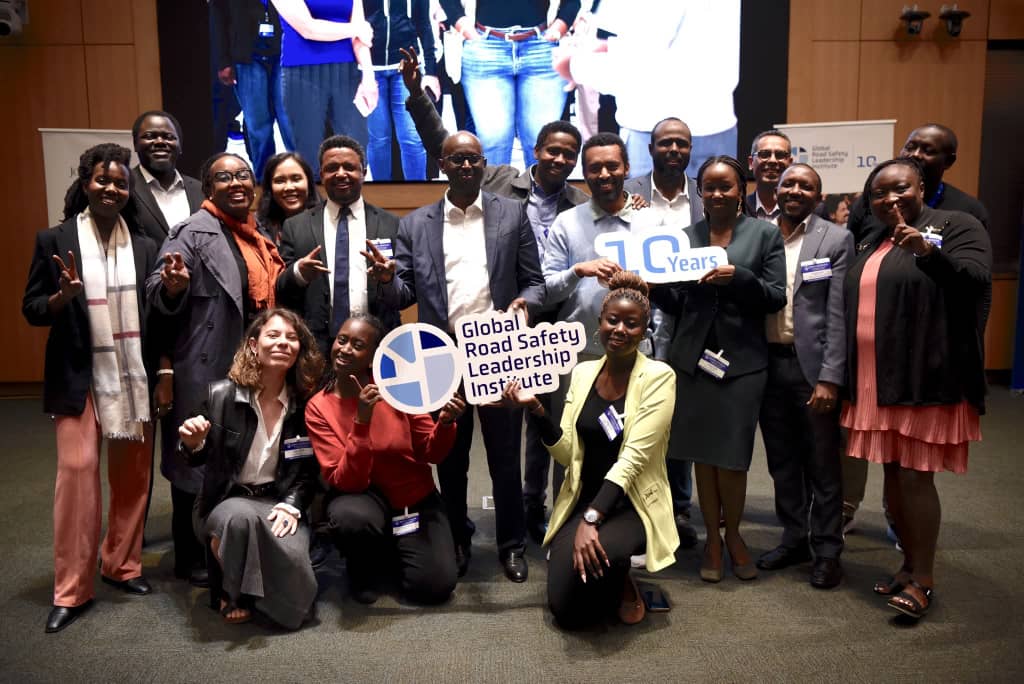 Course participants gathered around the Global Road Safety Leadership Institute sign marking its 10th year